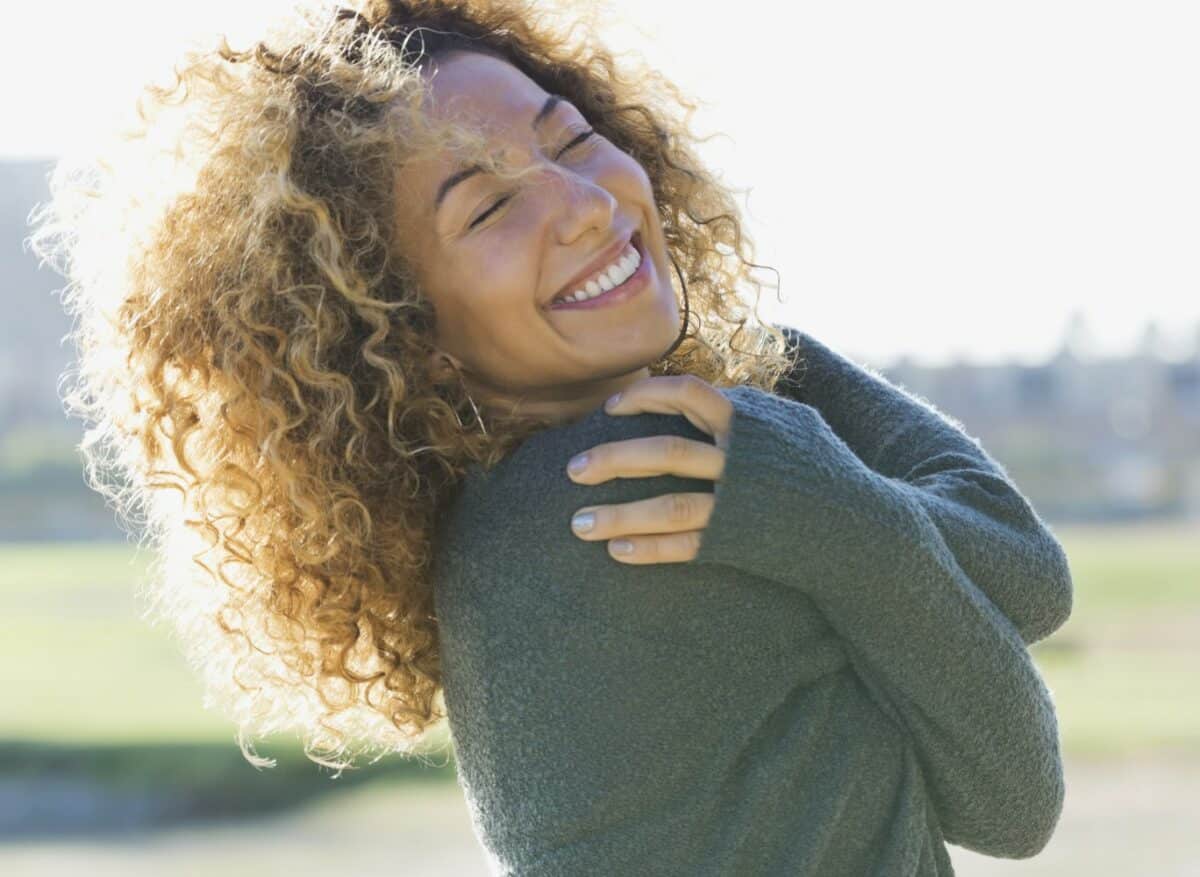 Smiling Woman With Eyes Closed Outdoors